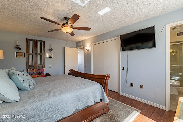 bedroom with wood finished floors, ensuite bath, ceiling fan, a closet, and a textured ceiling