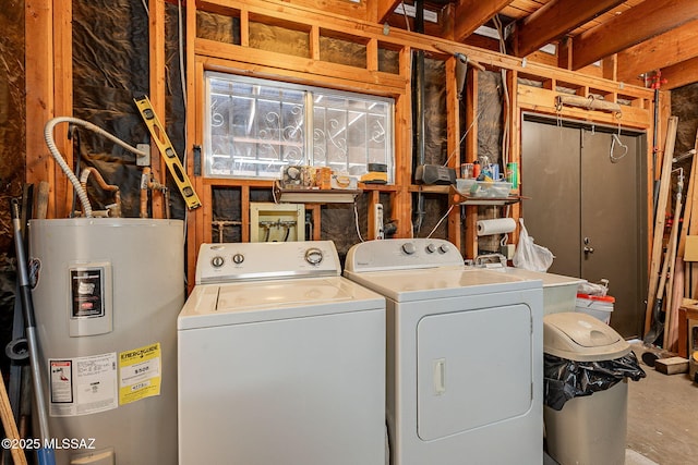 laundry area with water heater, laundry area, independent washer and dryer, and a sink