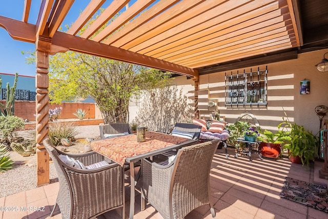 view of patio / terrace featuring outdoor dining space, a pergola, and fence