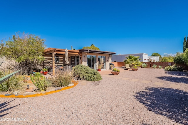 back of property featuring stucco siding, a patio, and fence