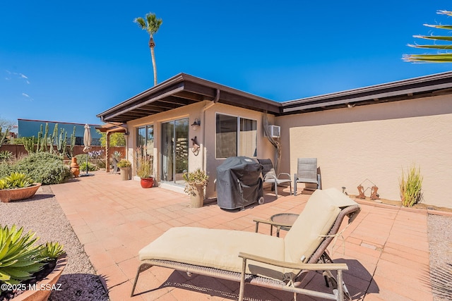 view of patio with grilling area and fence