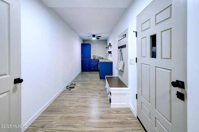 hallway with light wood-style floors and baseboards