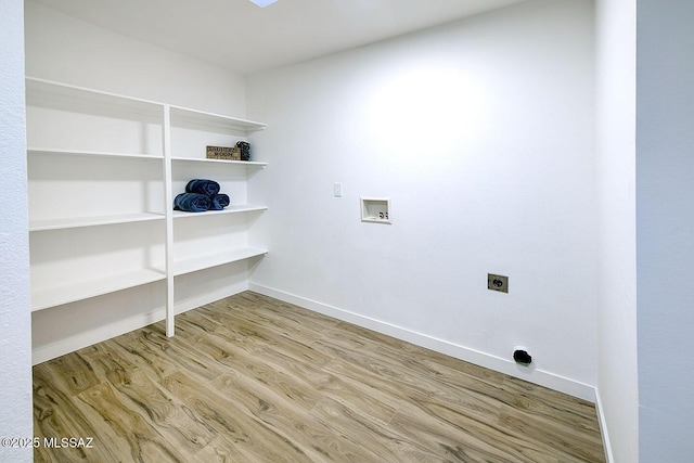 washroom featuring baseboards, laundry area, hookup for a washing machine, wood finished floors, and electric dryer hookup