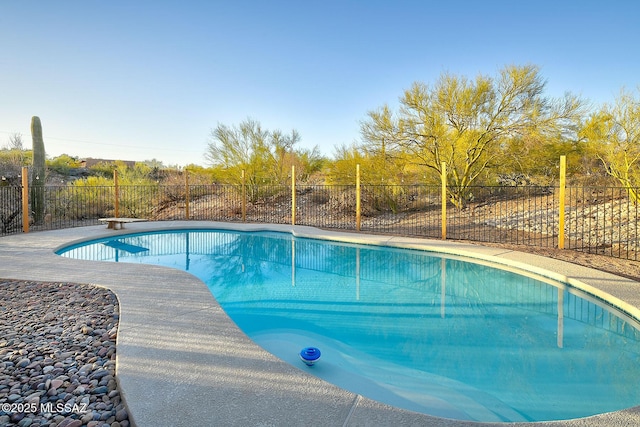 view of swimming pool with a diving board, a fenced in pool, and fence private yard