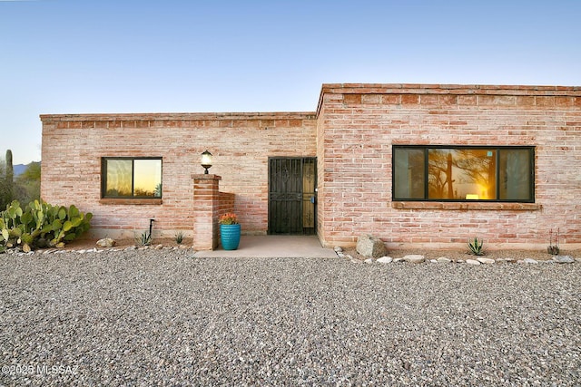 view of front of house featuring brick siding