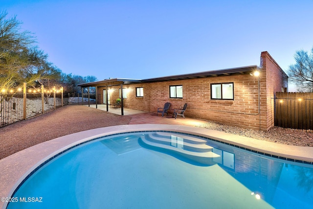 view of pool featuring a fenced backyard and a patio