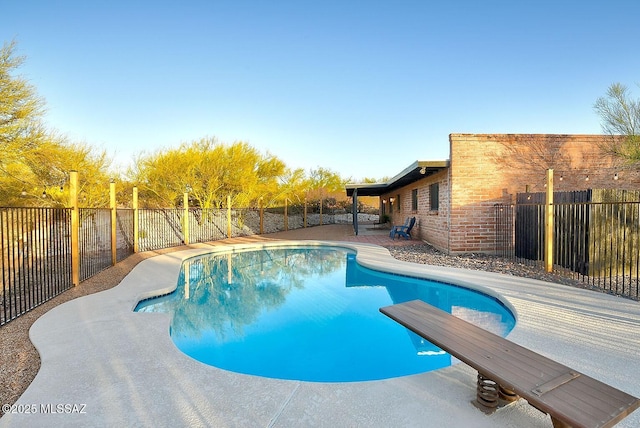 view of swimming pool featuring a fenced in pool, a patio, and a fenced backyard