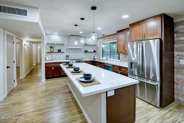 kitchen with visible vents, a sink, stainless steel fridge with ice dispenser, dishwasher, and open shelves