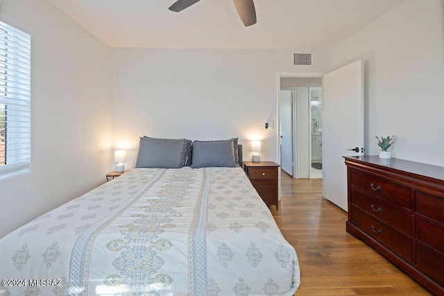 bedroom featuring wood finished floors, ceiling fan, and visible vents