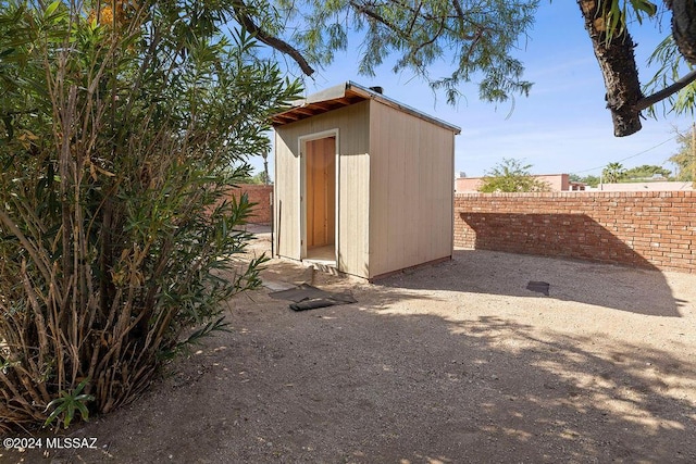 view of shed with fence