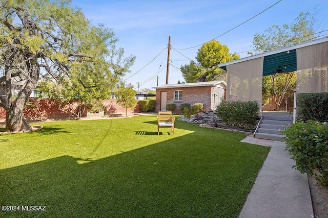 view of yard with an outbuilding and fence
