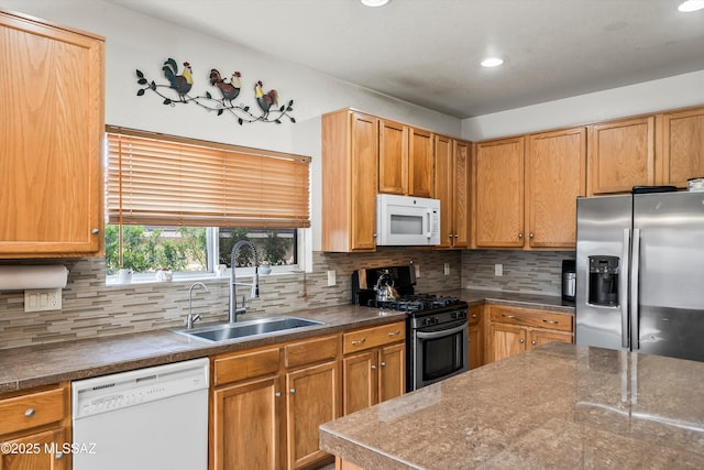 kitchen with a sink, recessed lighting, backsplash, and stainless steel appliances