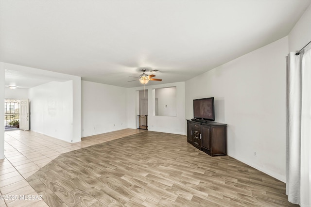 unfurnished living room with light wood finished floors and a ceiling fan