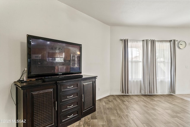 living area with light wood-style floors and baseboards