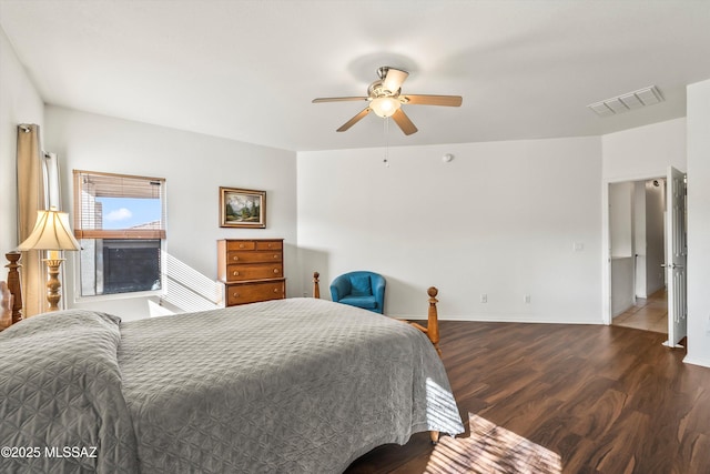 bedroom featuring visible vents, baseboards, wood finished floors, and a ceiling fan