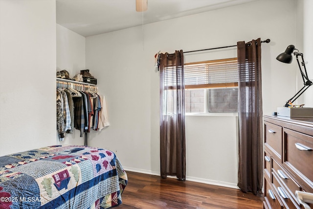 bedroom featuring baseboards, dark wood-style flooring, and ceiling fan