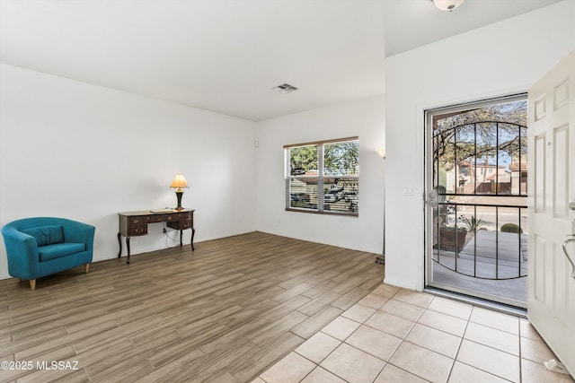 living area featuring visible vents and light wood finished floors