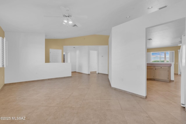 unfurnished room with light tile patterned floors, baseboards, visible vents, lofted ceiling, and ceiling fan