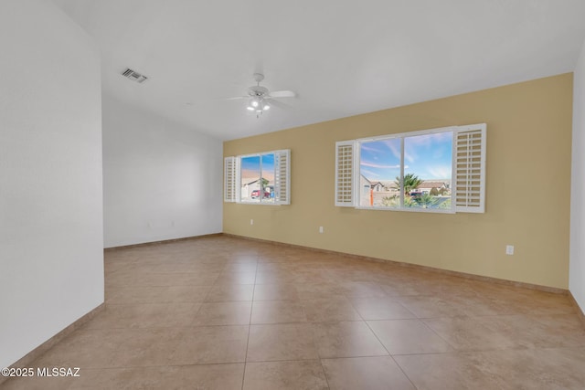 unfurnished room with visible vents, baseboards, ceiling fan, vaulted ceiling, and light tile patterned flooring