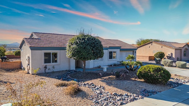 view of front of house with stucco siding and a tiled roof