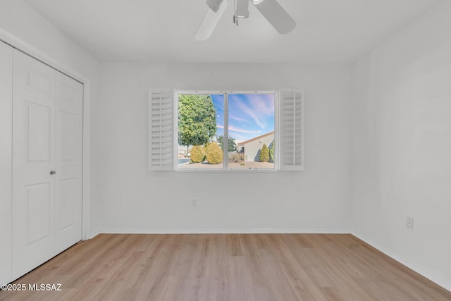 unfurnished bedroom with a closet, light wood-type flooring, and baseboards