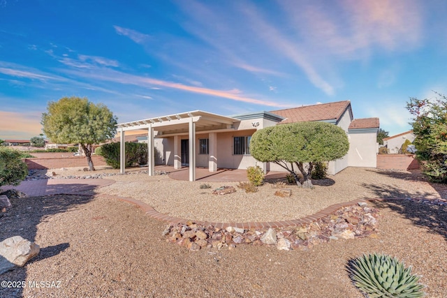 back of property featuring stucco siding, a patio, and a pergola