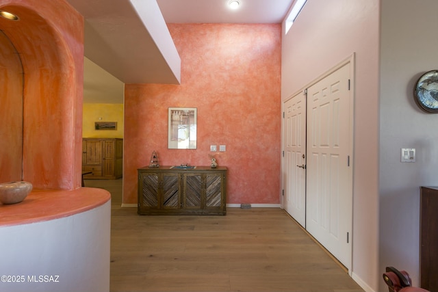 4920 W Harris Hawk Pl, Tucson, AZ 85745 - corridor with wood finished floors, baseboards, and a towering ceiling