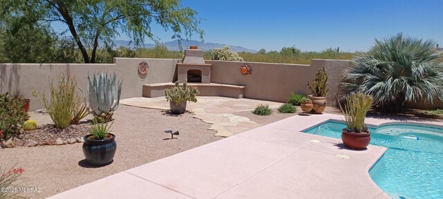 16311 S Creosote View Ln, Vail, AZ 85641 - view of patio / terrace featuring an outdoor fireplace, fence, and a mountain view