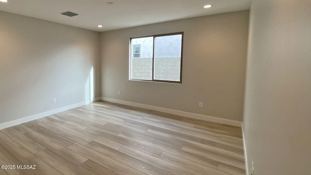 spare room featuring visible vents, recessed lighting, baseboards, and light wood finished floors