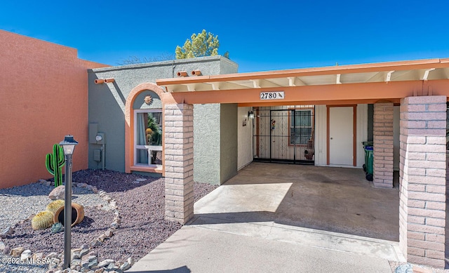 property entrance with stucco siding