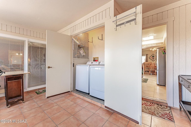 laundry area with light tile patterned floors, laundry area, and washing machine and dryer