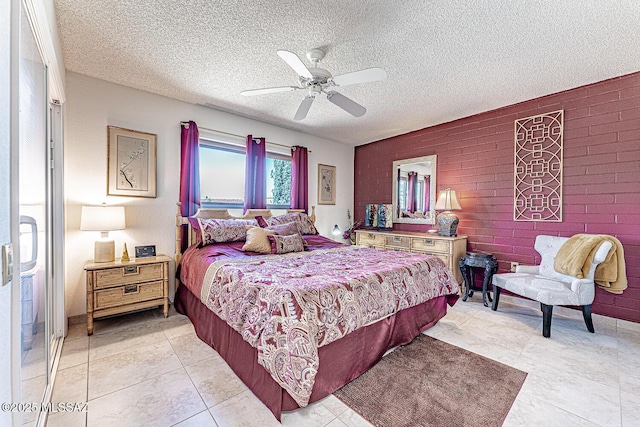 bedroom featuring light tile patterned flooring, brick wall, a textured ceiling, and ceiling fan