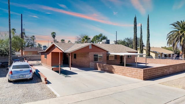 ranch-style house with brick siding and fence