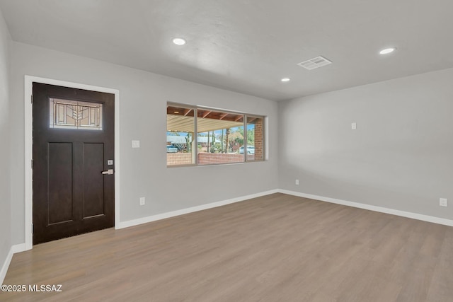 foyer entrance featuring visible vents, recessed lighting, baseboards, and wood finished floors