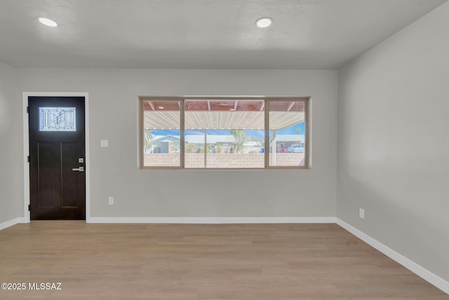 entryway featuring recessed lighting, baseboards, and light wood-style floors