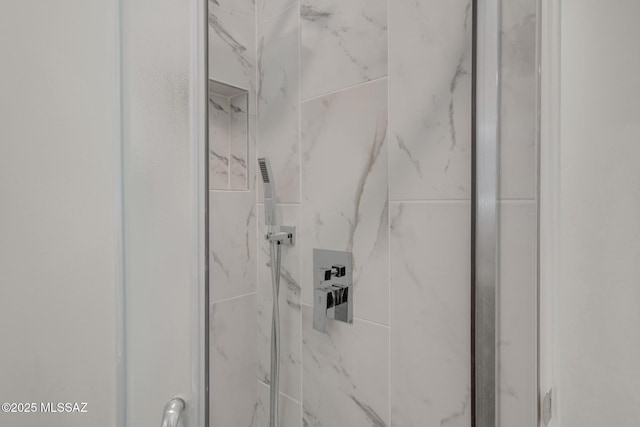 details featuring a marble finish shower