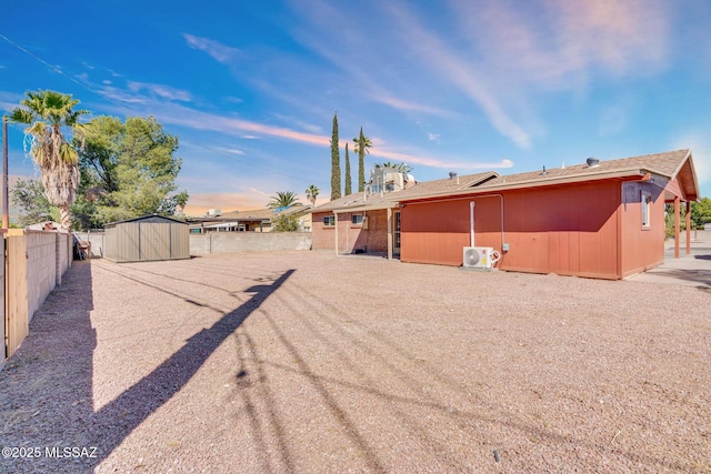 view of yard featuring an outbuilding, a storage unit, and a fenced backyard