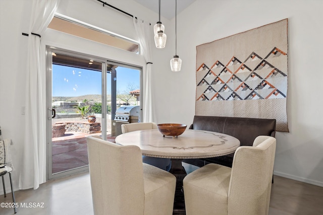 dining area with concrete floors and baseboards