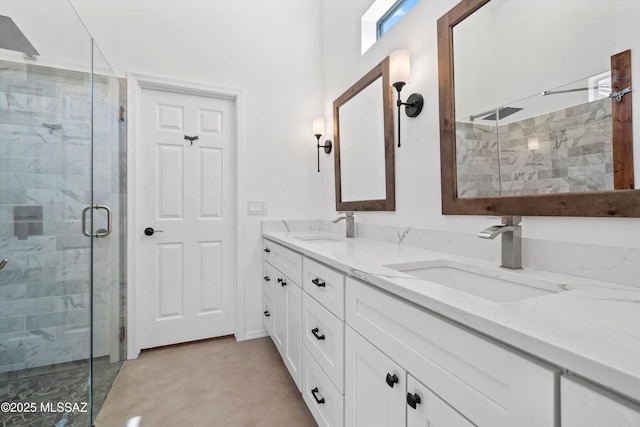 full bathroom featuring a sink, a stall shower, and double vanity