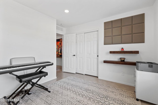 office space with recessed lighting, visible vents, and baseboards