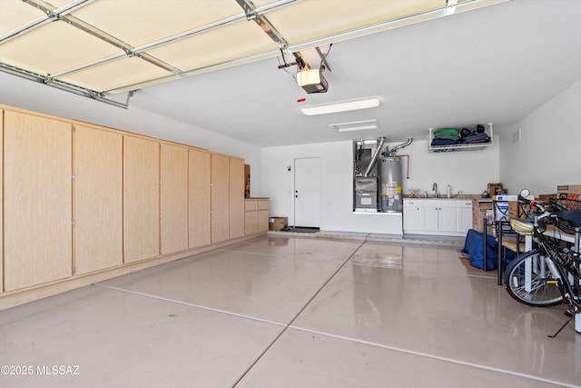 garage featuring a garage door opener, water heater, and a sink