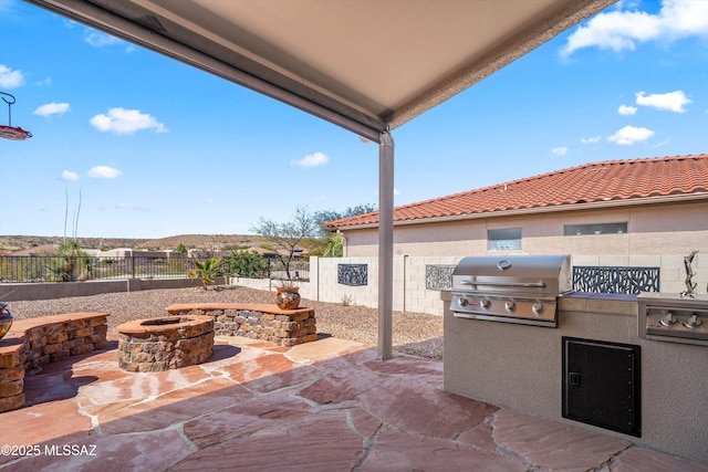 view of patio / terrace with an outdoor fire pit, area for grilling, a fenced backyard, and a grill