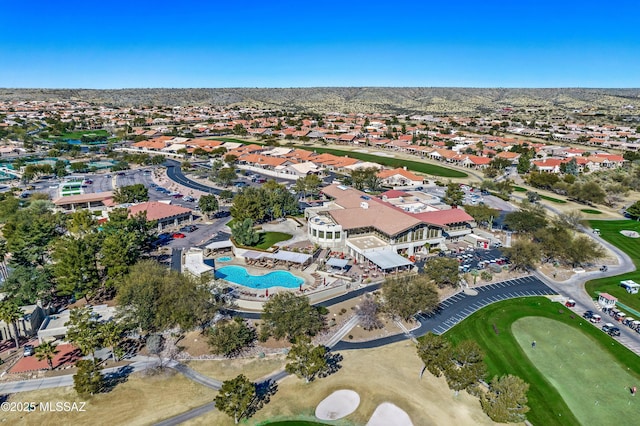 drone / aerial view featuring golf course view and a residential view