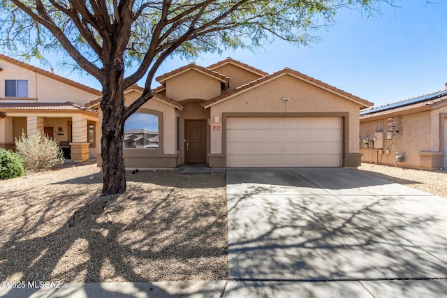 view of front of home with concrete driveway, an attached garage, and stucco siding