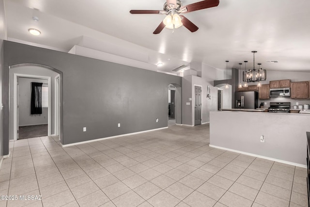 unfurnished living room with visible vents, lofted ceiling, light tile patterned floors, arched walkways, and a ceiling fan