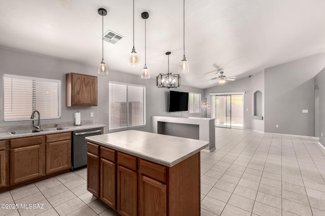 kitchen with visible vents, light tile patterned flooring, a sink, dishwasher, and a center island