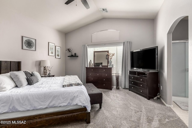 bedroom with a ceiling fan, carpet, visible vents, arched walkways, and vaulted ceiling