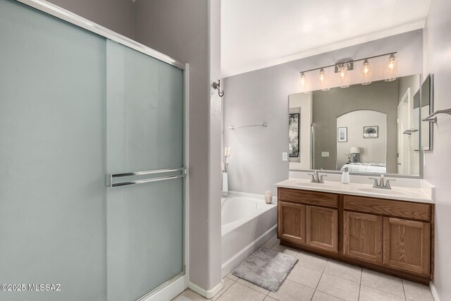 bathroom with a sink, a garden tub, a stall shower, and tile patterned floors