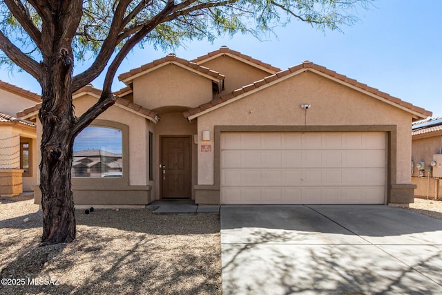 view of front of home with concrete driveway, a garage, and stucco siding