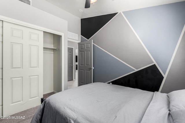 carpeted bedroom featuring a closet, lofted ceiling, and a ceiling fan